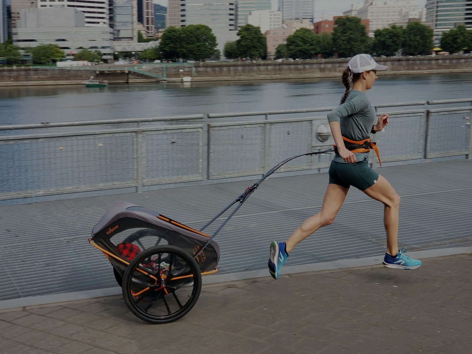 Lady running with innovative child carrier