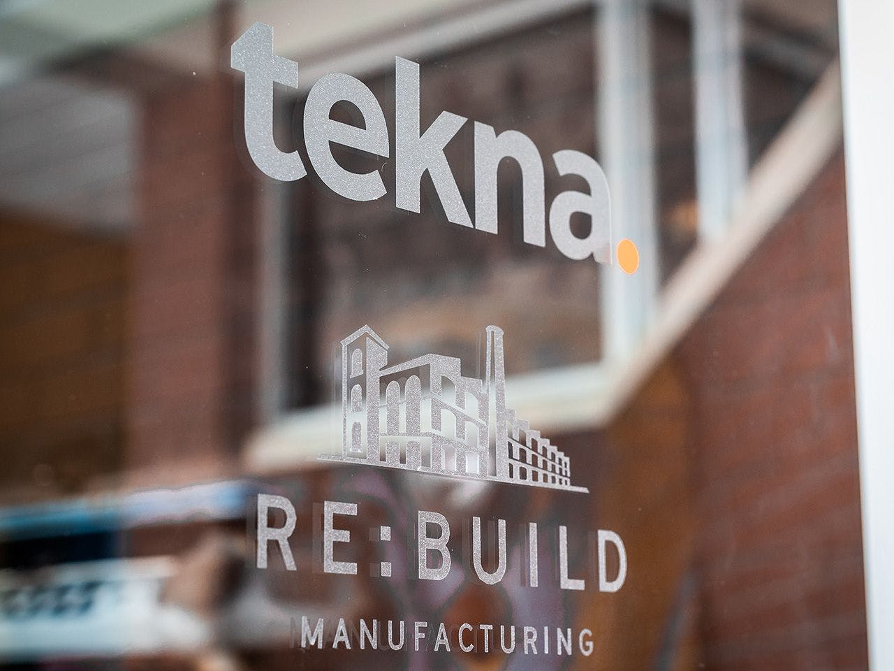 Tekna Re:Build vinyl sign on glass door