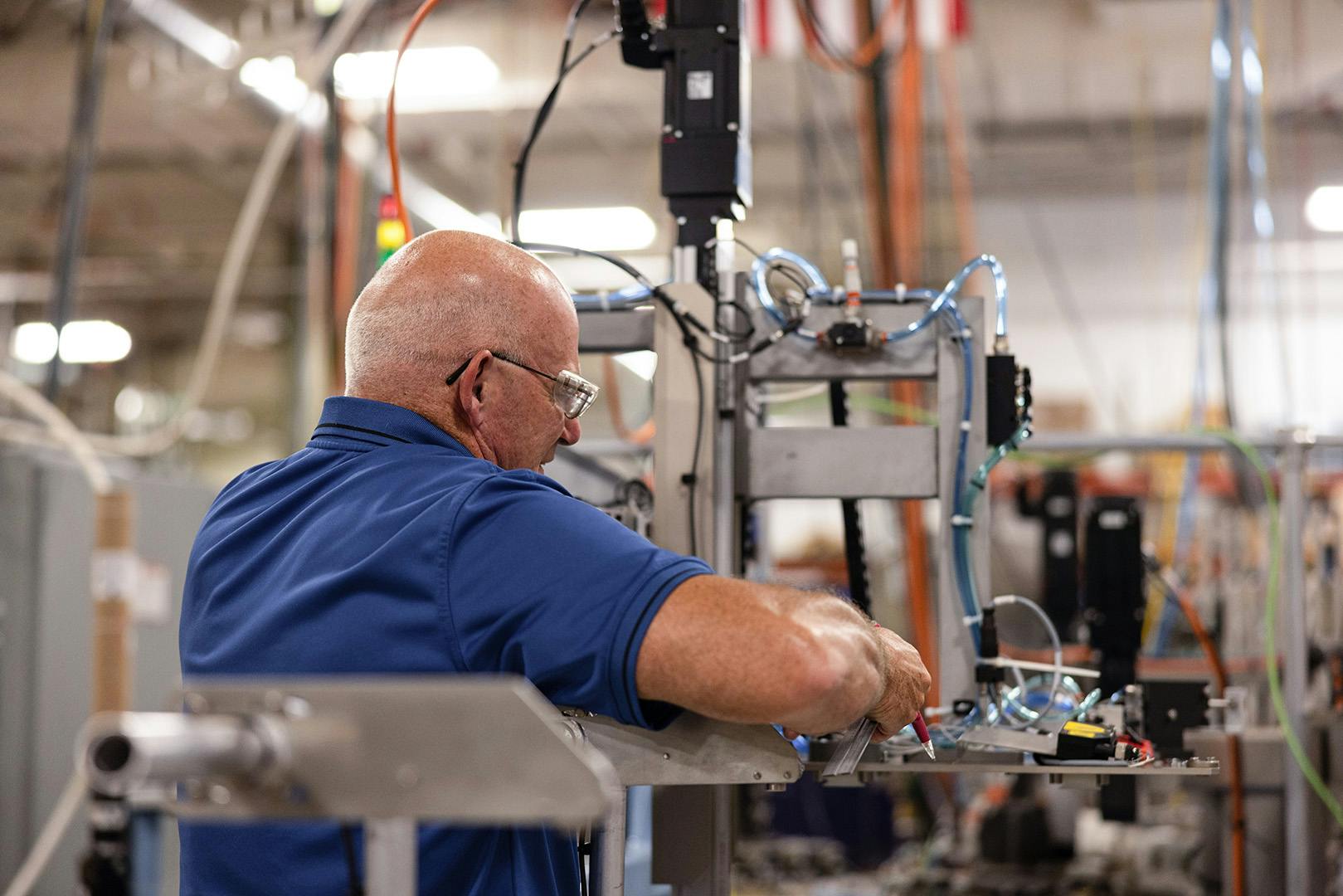 Man working on an automated piece of equipment