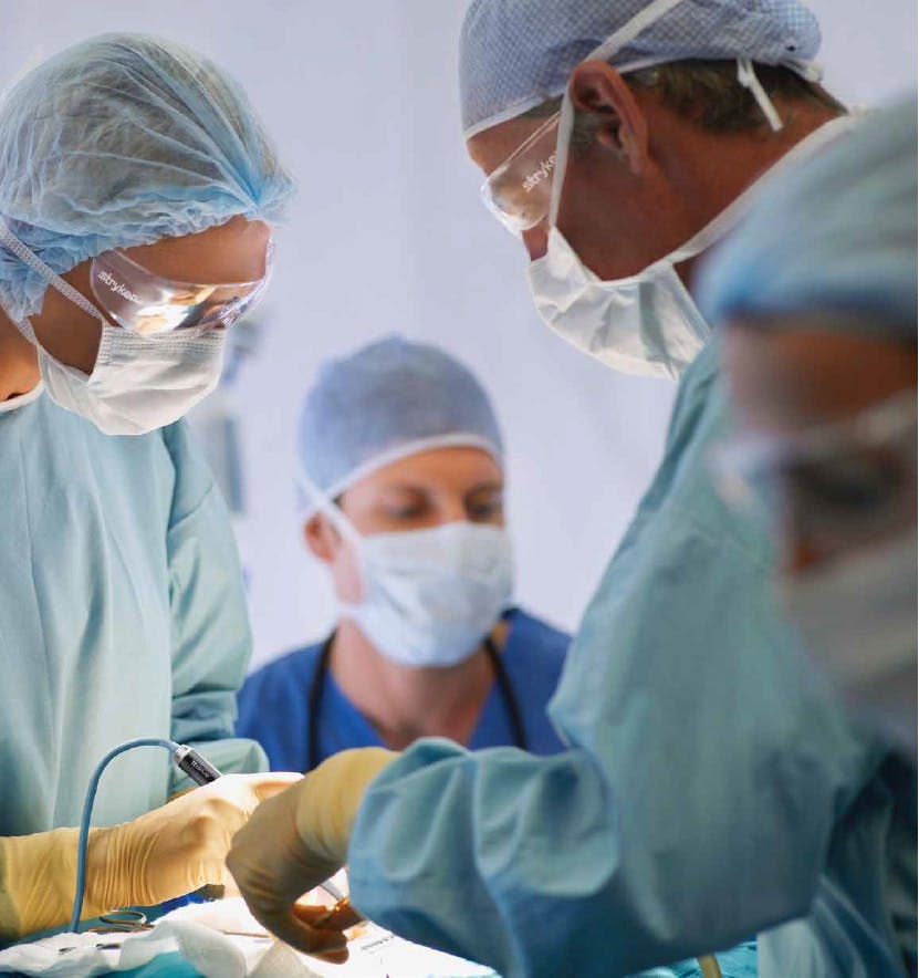 Surgeons and nurses working in an operating room with utensils