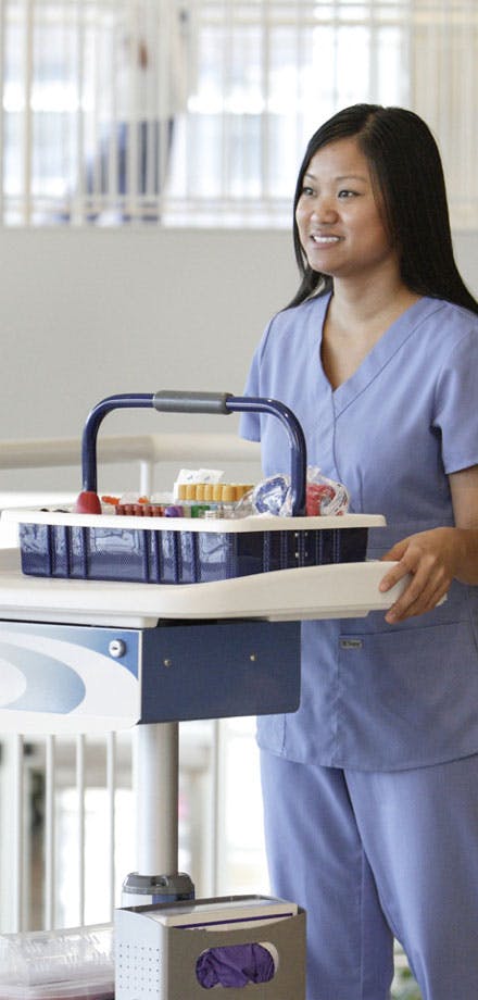 Nurse smiling and pushing Medscape cart