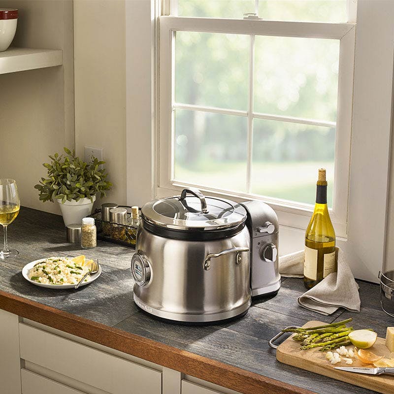 Kitchenaid multi cooker sitting on counter with food and drink photograph