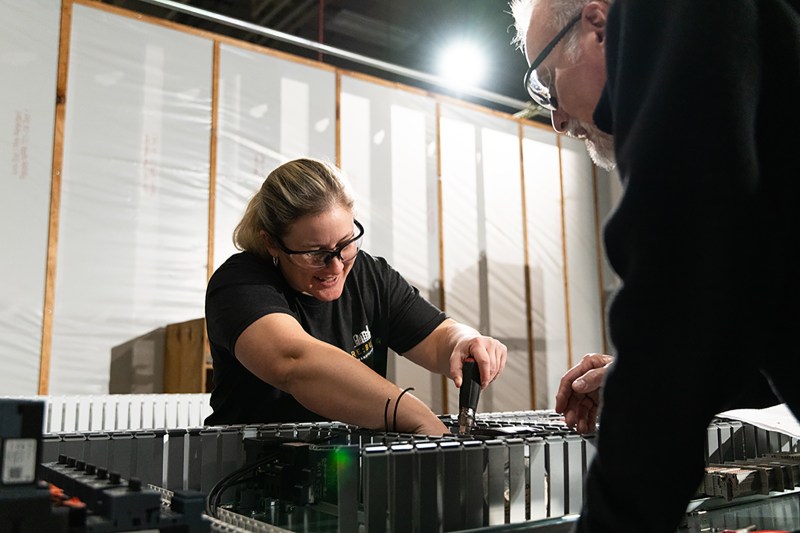 Employees working together on machine